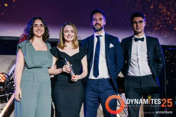Dynamites Award Winners and Award Presenter posing with award