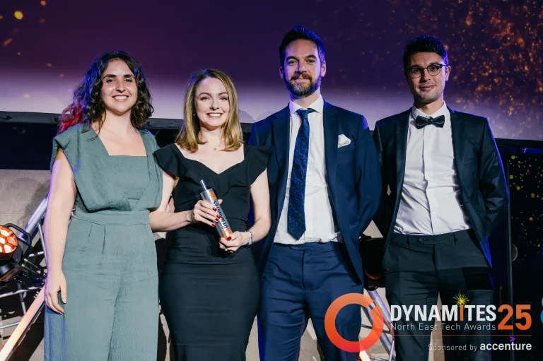 Dynamites Award Winners and Award Presenter posing with award