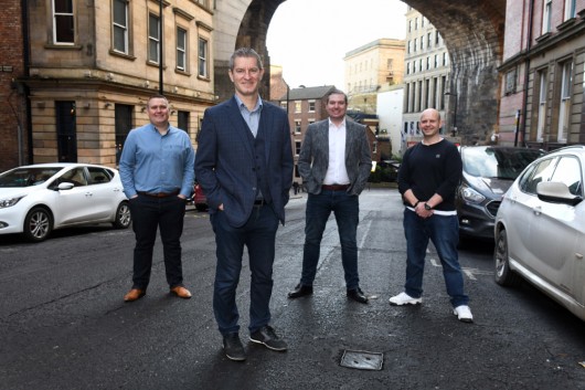 Four men standing at the bottom of Dean Street in Newcastle Upon Tyne