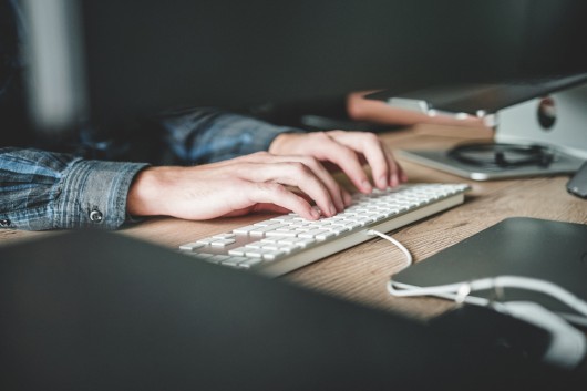 Person typing on a keyboard