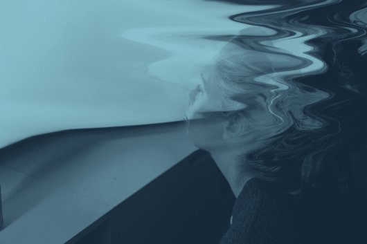 Abstract image of a woman's profile in blue